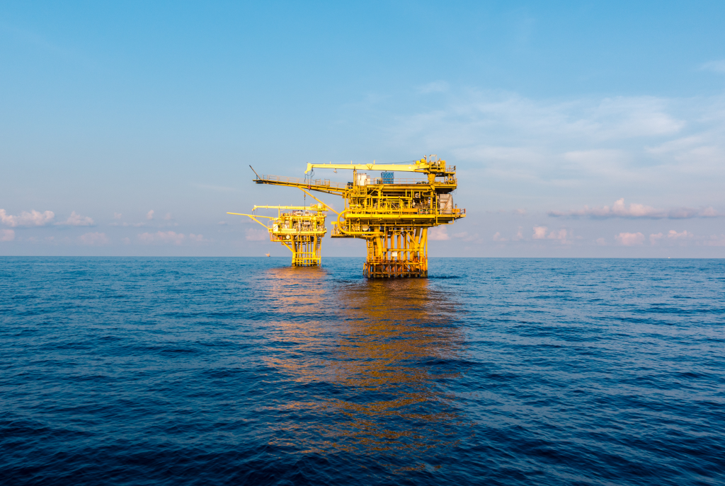 two oil platforms in calm blue ocean
